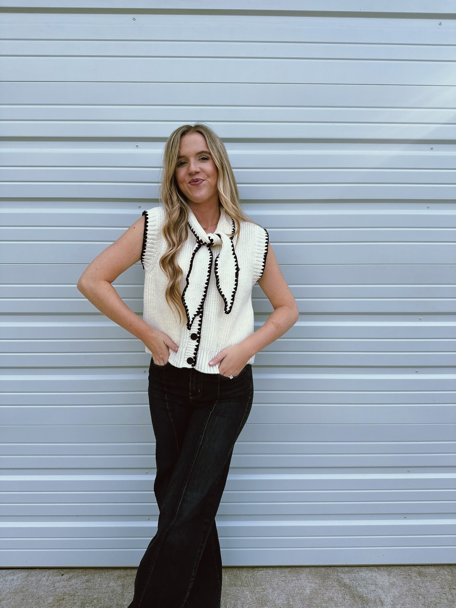 white top with neck tie and black accents 